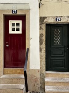 A red door and green door in Lisbon.