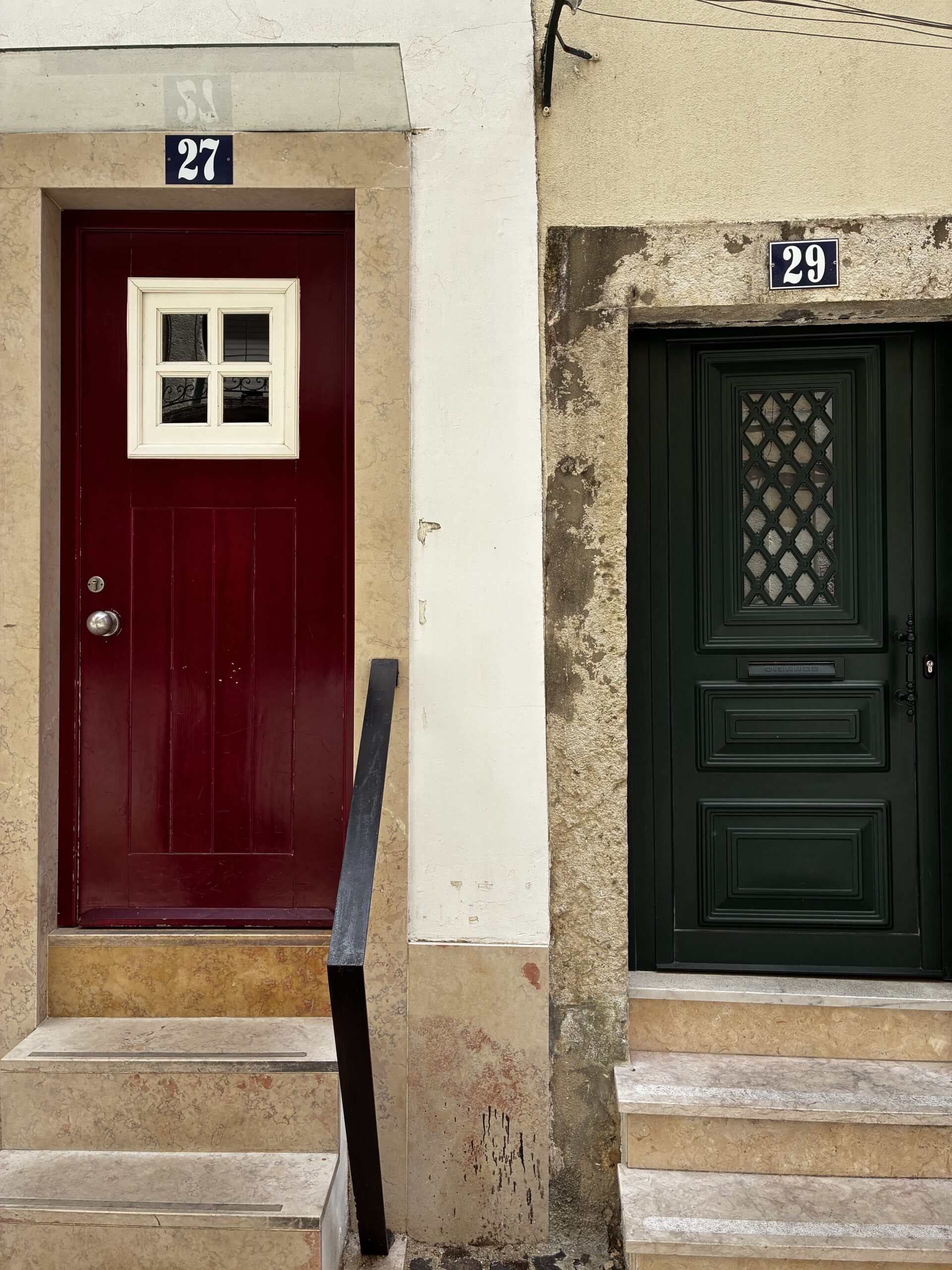 A red door and green door in Lisbon.